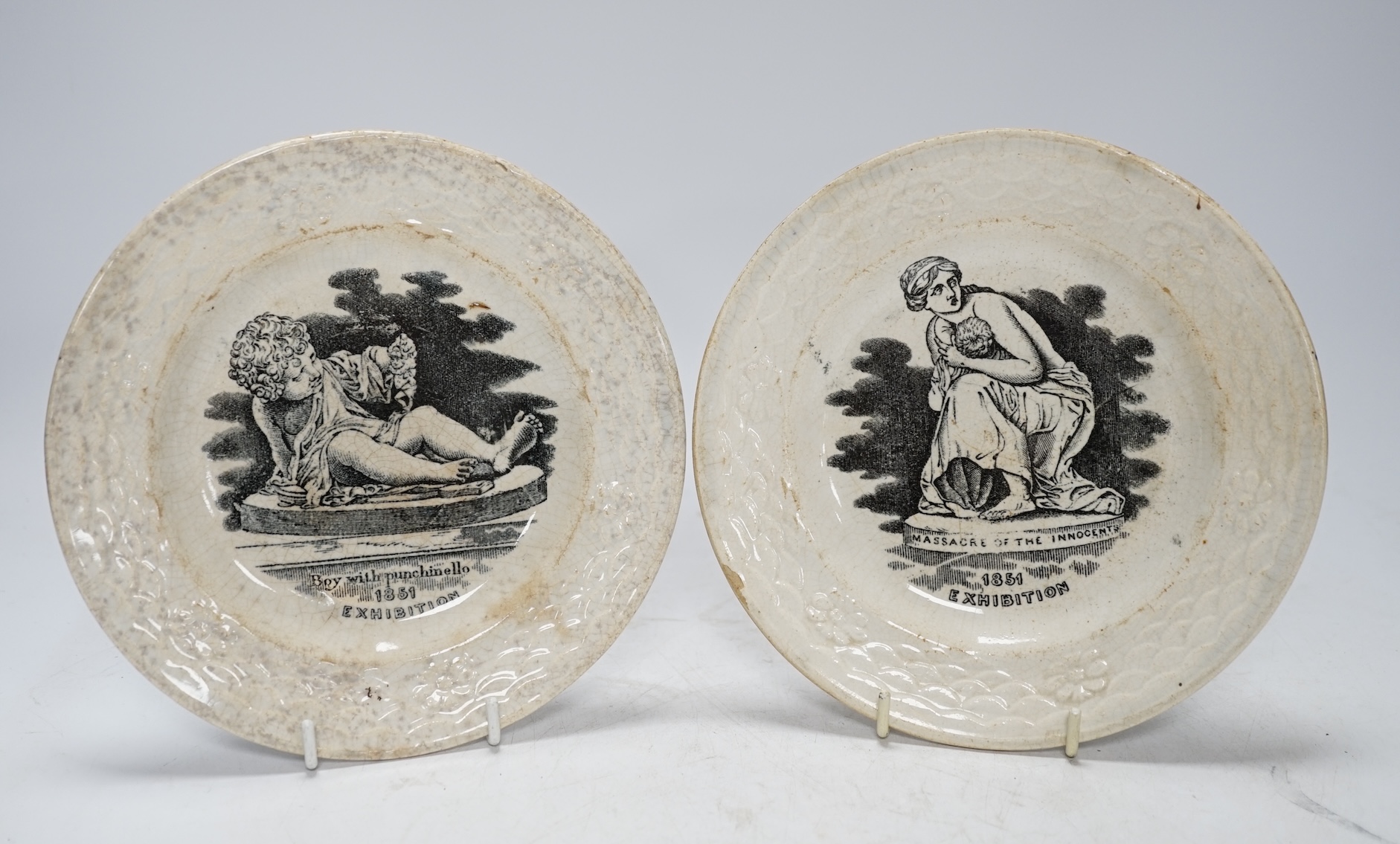 From the Studio of Fred Cuming. A pair of printed 1851 exhibition plates ‘Boy with Punchinello’ and ‘Massacre of the Innocent’, 17cm in diameter. Condition - poor to fair